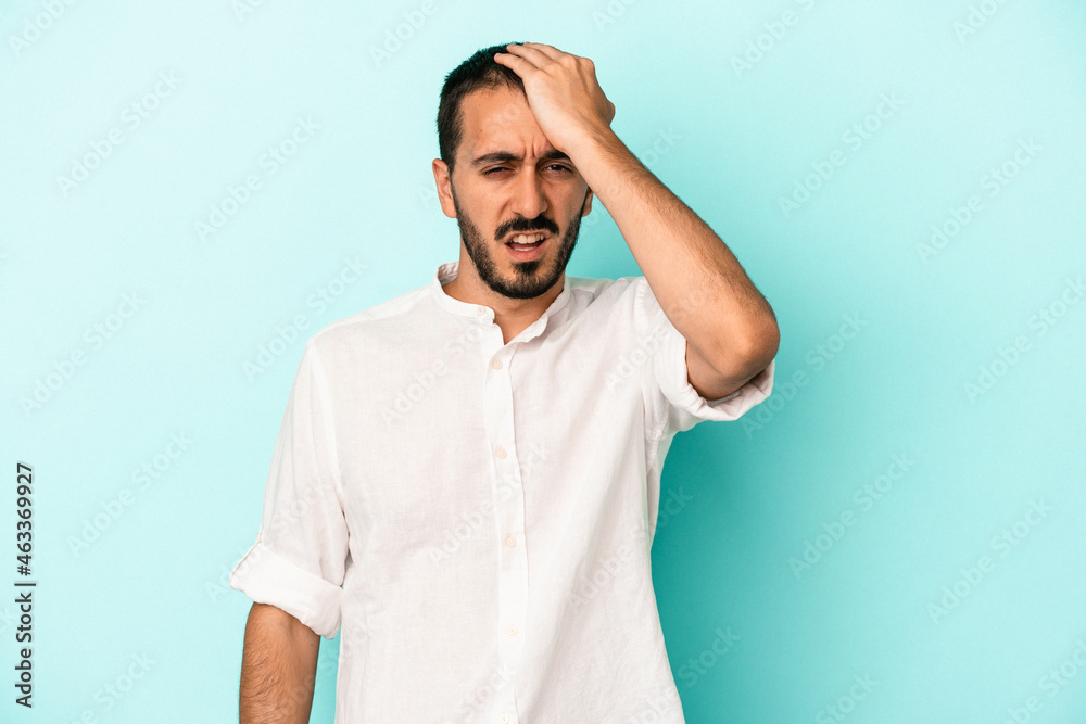 Young caucasian man isolated on blue background forgetting something, slapping forehead with palm and closing eyes. Young caucasian man isolated on blue background forgetting something, slapping forehead with palm and closing eyes.