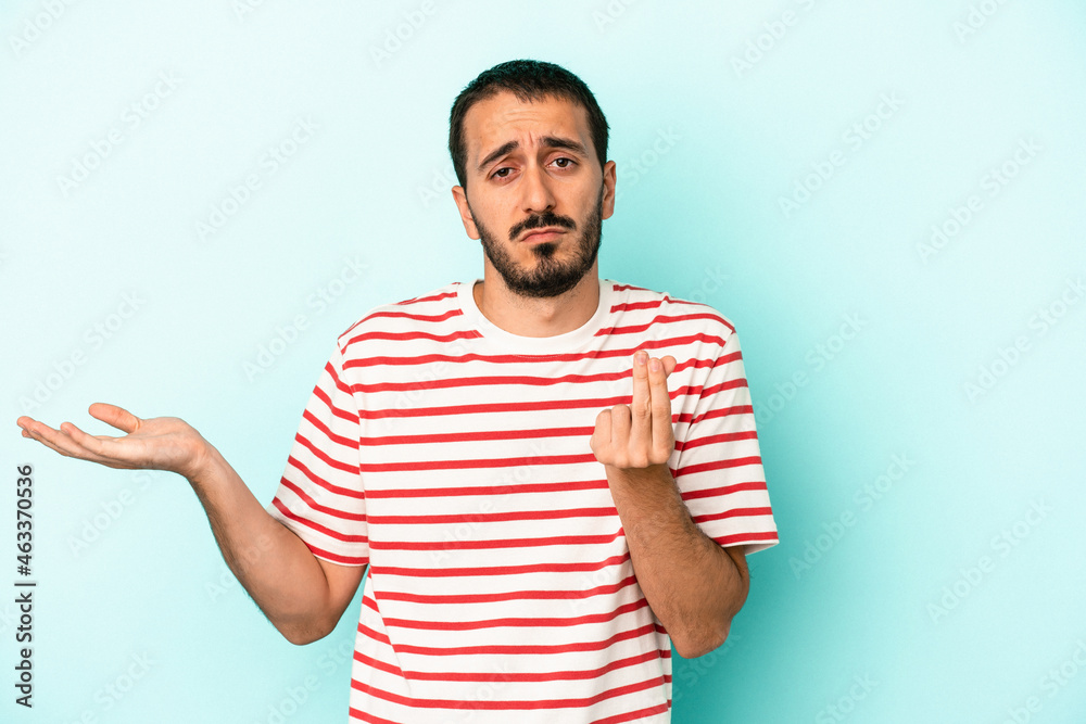 Young caucasian man isolated on blue background showing that she has no money. Young caucasian man isolated on blue background showing that she has no money.