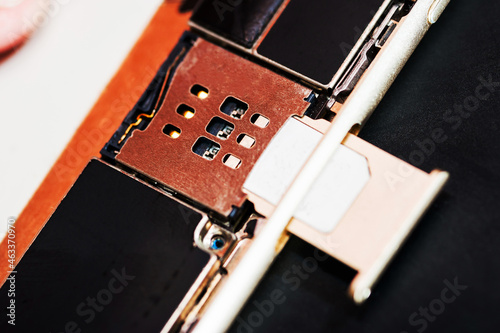 The SIM card is inserted into the smartphone, close-up,