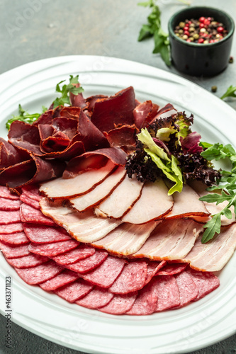 antipasti with salami, prosciutto, ham, Meat platter with selection. vertical image. top view