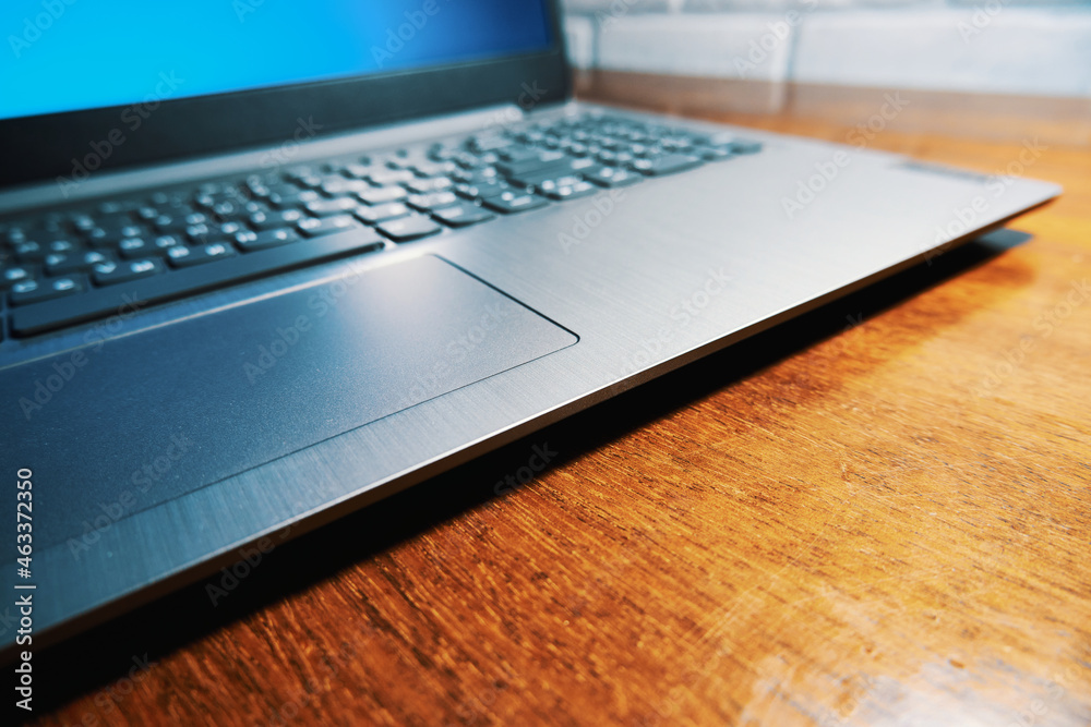 Modern laptop on a polished wooden table Modern laptop on a polished wooden table