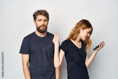 Man and woman with a phone in hand emotions isolated background