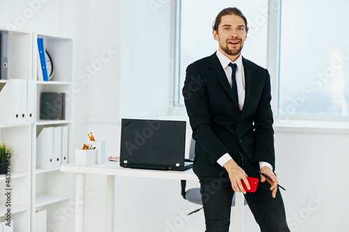 man in a suit in the office with documents executive
