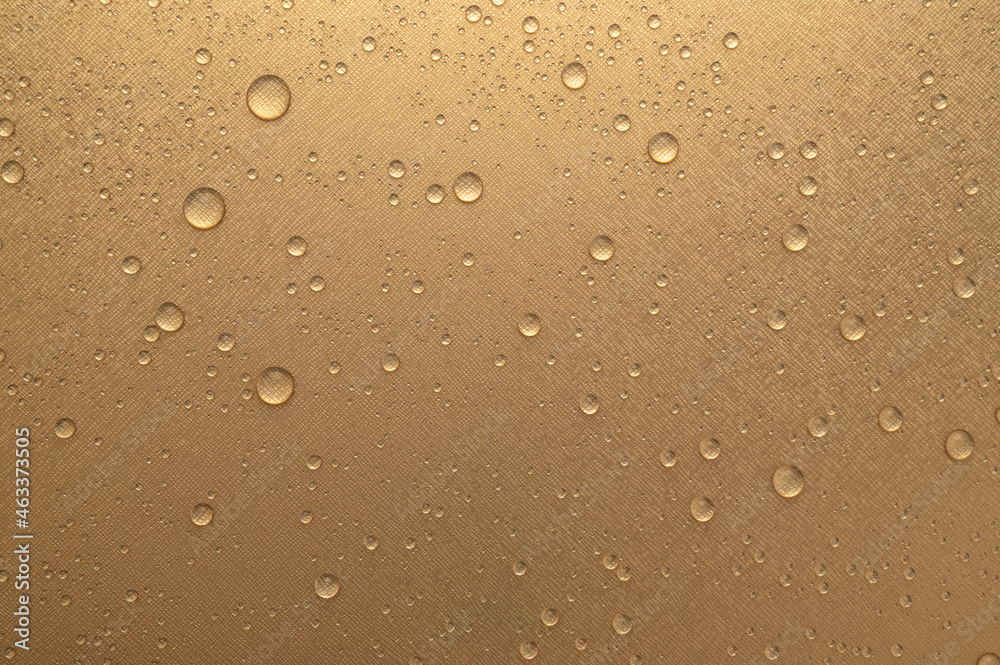 Water drop on gold color wall texture background