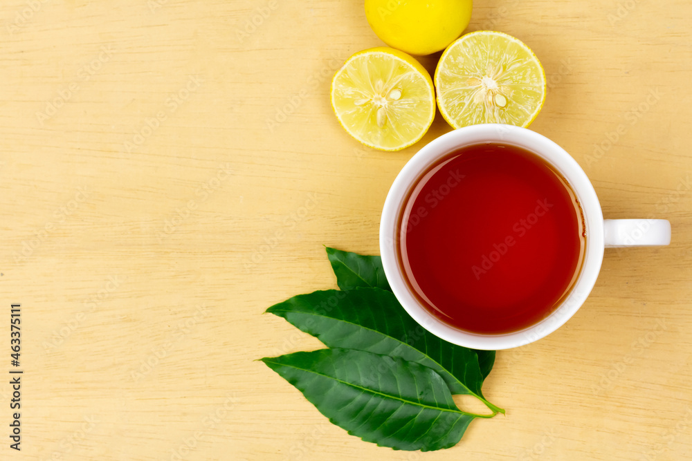 Neem tea in ceramic cup with neem leaf and lemon on wooden background, top view. Neem tea in ceramic cup with neem leaf and lemon on wooden background, top view.