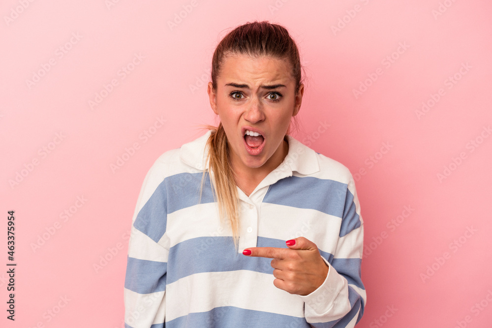 Young Russian woman isolated on pink background excited holding a copy space on palm.