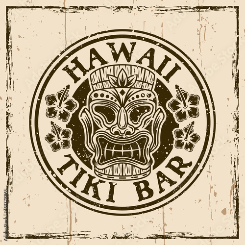 Hawaiian tiki wooden head colored vector round vintage emblem, badge, label, logo or t-shirt print. Illustration on background with grunge textures and frame vector illustration photo