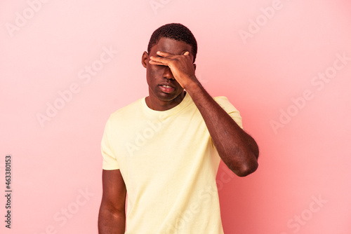 Young African American man isolated on pink background touching temples and having headache.