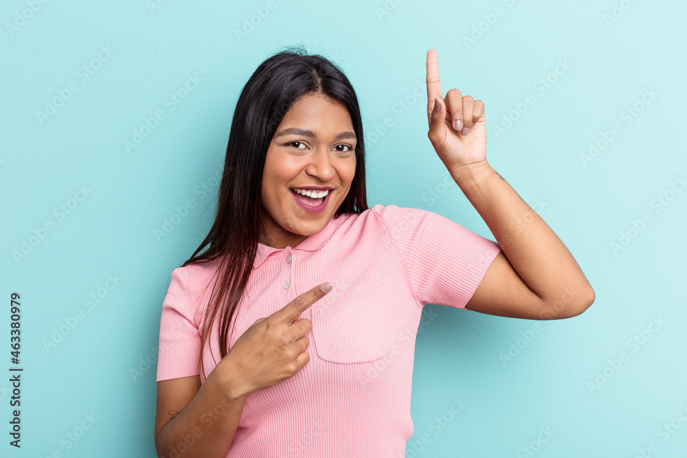 Young Venezuelan woman isolated on blue background dancing and having fun. Young Venezuelan woman isolated on blue background dancing and having fun.