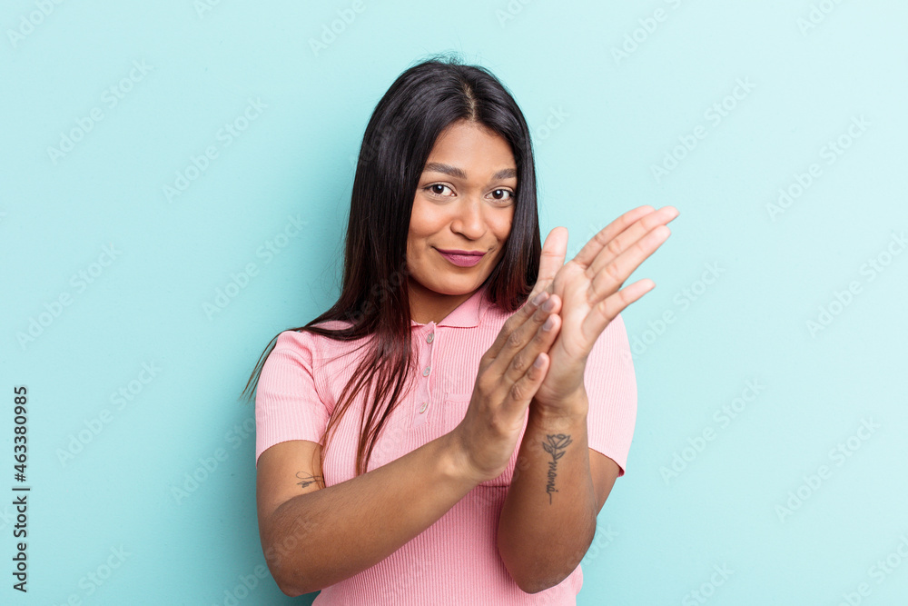 Young Venezuelan woman isolated on blue background feeling energetic and comfortable, rubbing hands confident. Young Venezuelan woman isolated on blue background feeling energetic and comfortable, rubbing hands confident.