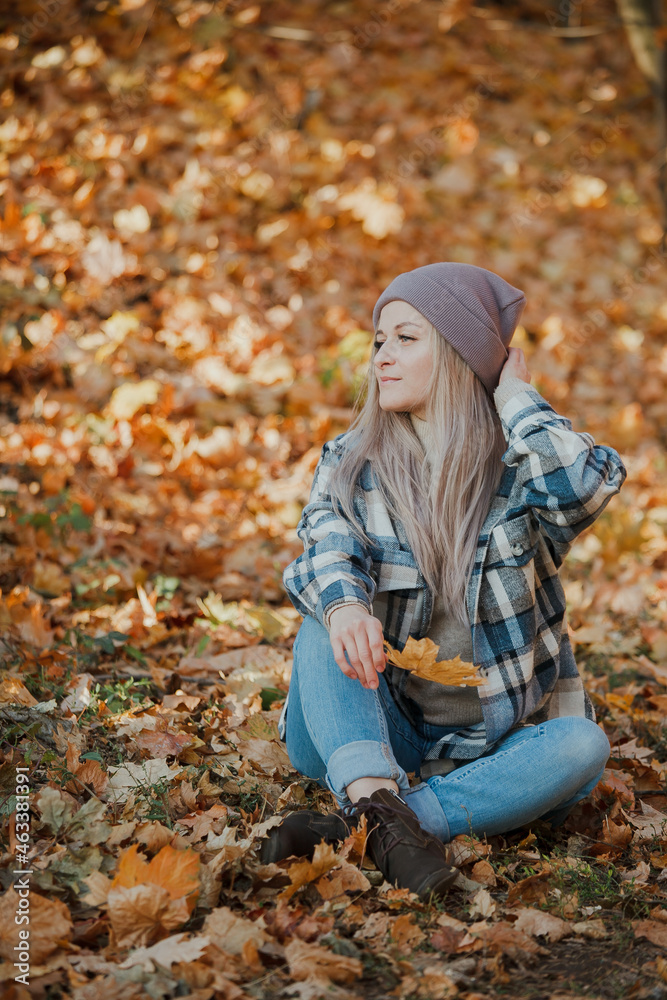 a blonde girl in a plaid shirt in the autumn forest a blonde girl in a plaid shirt in the autumn forest