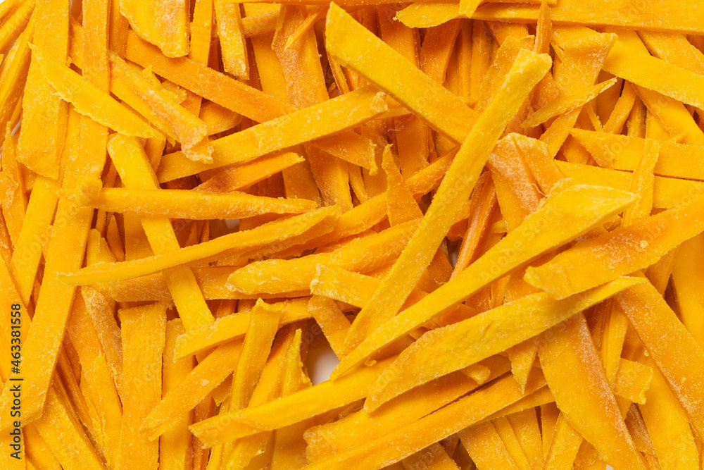 Dry tasty mango slices as a background. Dry tasty mango slices as a background.
