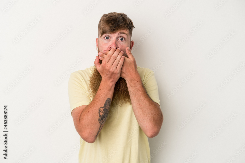 Young caucasian ginger man with long beard isolated on white background covering mouth with hands looking worried. Young caucasian ginger man with long beard isolated on white background covering mouth with hands looking worried.