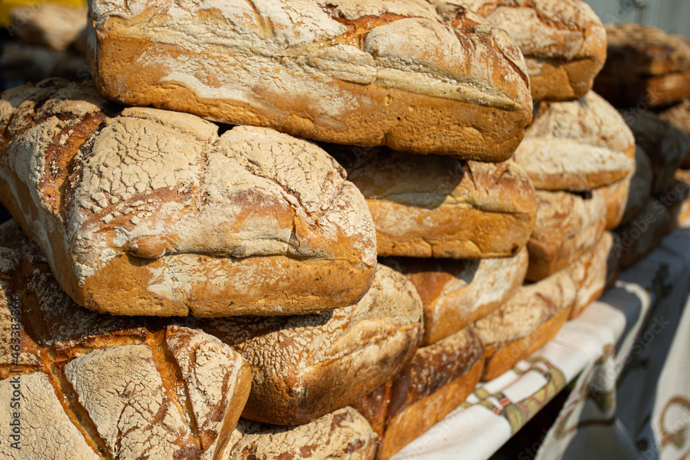 Loaves of bread lying on the counter. Sale of flour products. Breads. Products at the fair