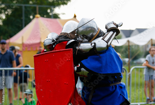 Two men in reconstructed historical costumes of knights of Lower Silesia are fighting among themselves photo