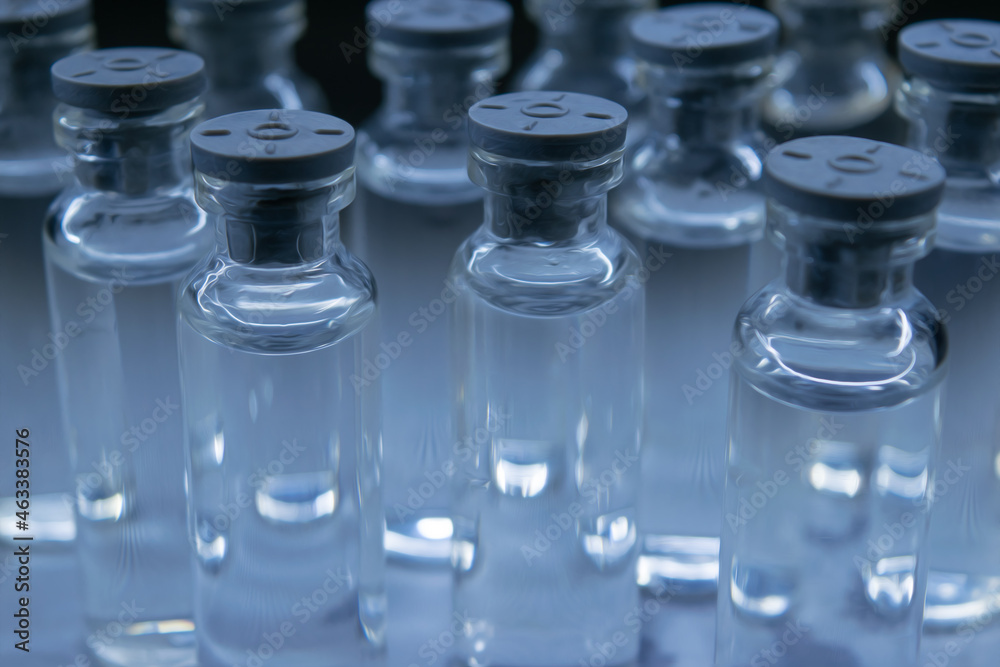 Several bottles with clear liquid on the table. Several bottles with clear liquid on the table.