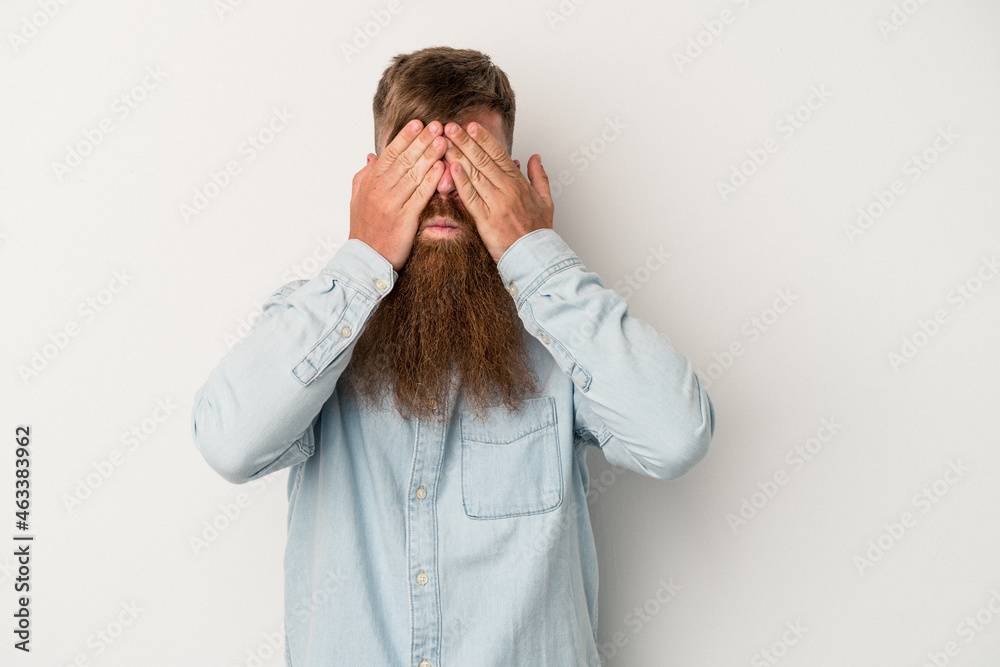 Young caucasian ginger man with long beard isolated on white background afraid covering eyes with hands. Young caucasian ginger man with long beard isolated on white background afraid covering eyes with hands.