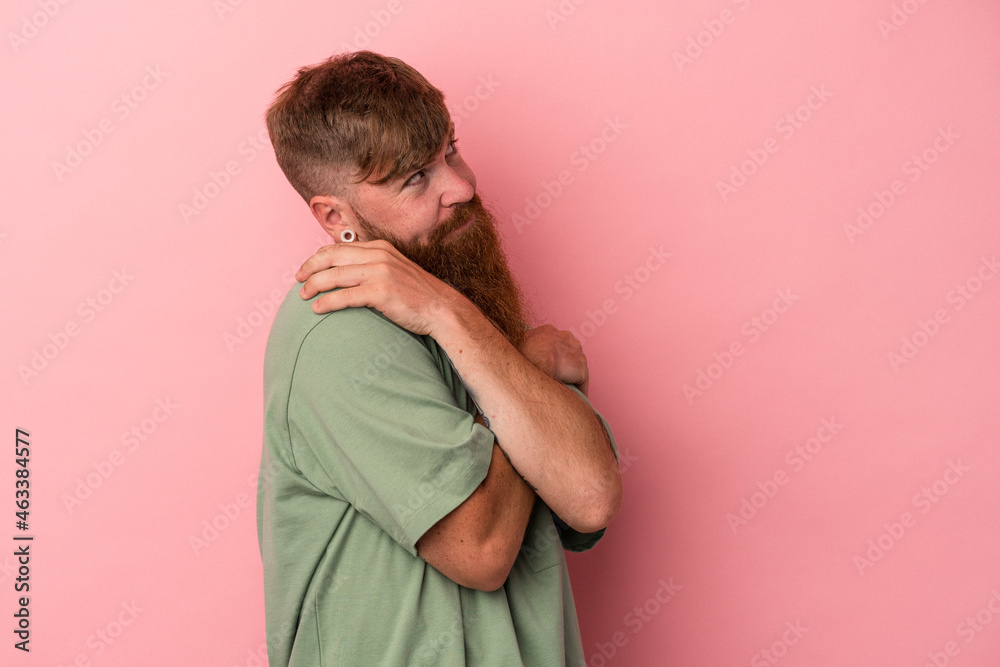 Young caucasian ginger man with long beard isolated on pink background hugs, smiling carefree and happy. Young caucasian ginger man with long beard isolated on pink background hugs, smiling carefree and happy.