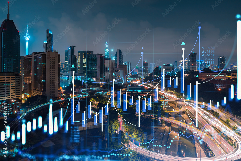 Fototapeta premium Stock market graph hologram, night panorama city view of Kuala Lumpur. KL is popular location to gain financial education in Malaysia, Asia. The concept of international research. Double exposure.