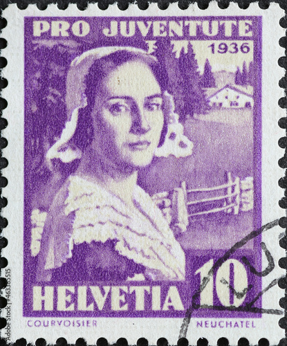 Switzerland - Circa 1936: a postage stamp printed in the Switzerland showing a historical woman portrait with hat in the traditional costume of the Canton of Neuchâtel.