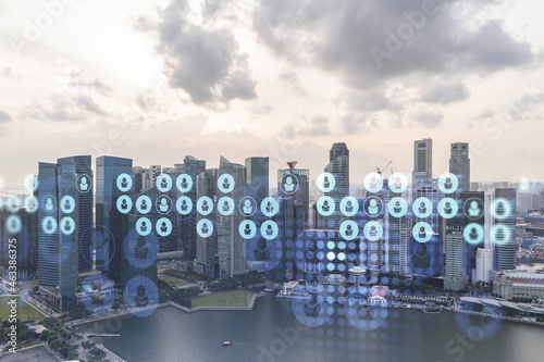 Hologram of social media icons over sunset panoramic cityscape of Singapore, Southeast Asia. The concept of people connections and career opportunities in international consulting. Multi exposure.