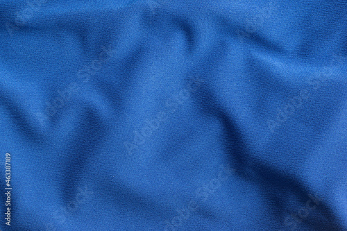 Texture of blue crumpled fabric with waves.