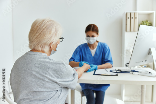 elderly woman and doctor patient examination medical office