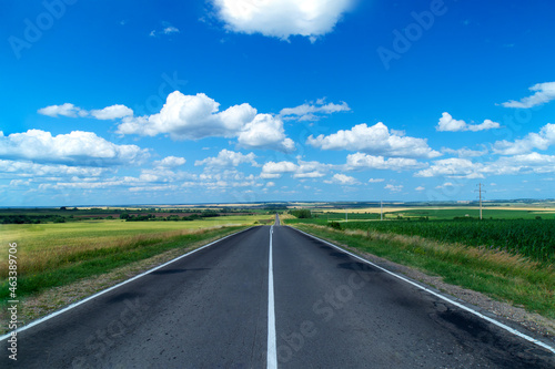 Russian rural highway stretching into the distance. Russian fields and simplicity. Daytime shooting. The clouds.