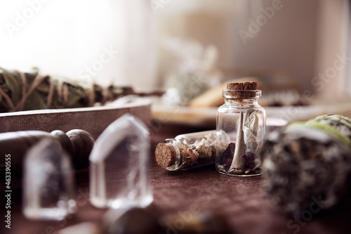 Detail of two glass jars with some medicinal herbs on an altar to perform esoteric rituals photo