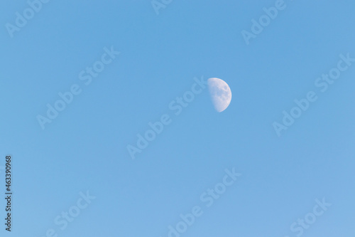 青空に浮かぶ白い半月 photo