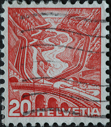 Switzerland - Circa 1936: a postage stamp printed in the Switzerland showing a permanent series with the Swiss landscape with the mountains and the railway and the track on the Gotthard photo