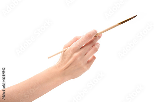 Female hand with brush on white background. Hand with a brush