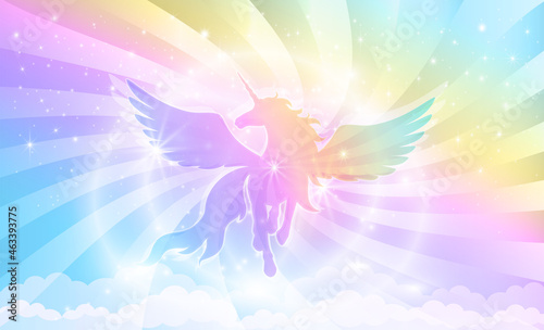 Silhouette of a unicorn with wings on a background of a rainbow sky with stars and rays of light.