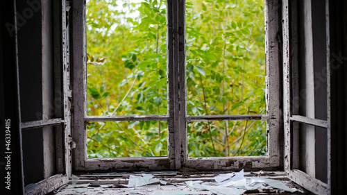 open window with old wooden frame. old window. finely broken glass. old house, retro. cracked window frame. cracked old paint, pieces of glass. space for text. large pieces of glass. close-up