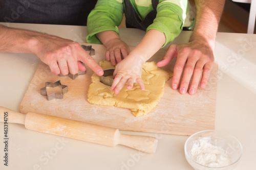 Kid cooking class together with father. Handmade Christmas dessert. Family Making cookie, Hands using rolling pin