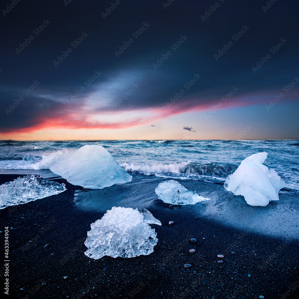 magical charming beautiful landscape with a piece of ice like a sculpture on the Diamond beach near glacier lagoon Jokulsarlon, Iceland at sunset. Exotic countries. Amazing places.