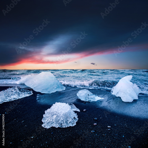 Obraz na płótnie magical charming beautiful landscape with a piece of ice like a sculpture on the Diamond beach near glacier lagoon Jokulsarlon, Iceland at sunset. Exotic countries. Amazing places. w salonie