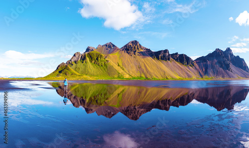 Obraz na płótnie silhouette of a man looking at beautiful landscape with most breathtaking mountains Vestrahorn on the Stokksnes peninsula in the mirror of the lake. (Meditation, antistress - concept). w salonie