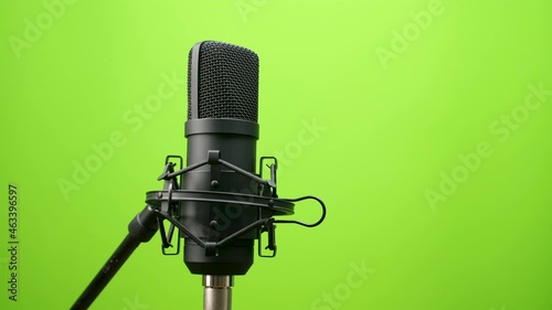 black Studio condenser microphone isolated on green screen background, Studio microphone, sound media, recording, camera orbit view 