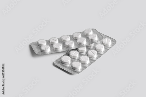 Tablets in foil packaging on a light background