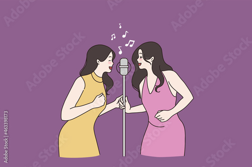 Smiling women friends have fun sing in microphone relax in karaoke bar together. Happy millennial girls singers preform song in duo, rest on stage. Artist, hobby, music concept. Vector illustration. 