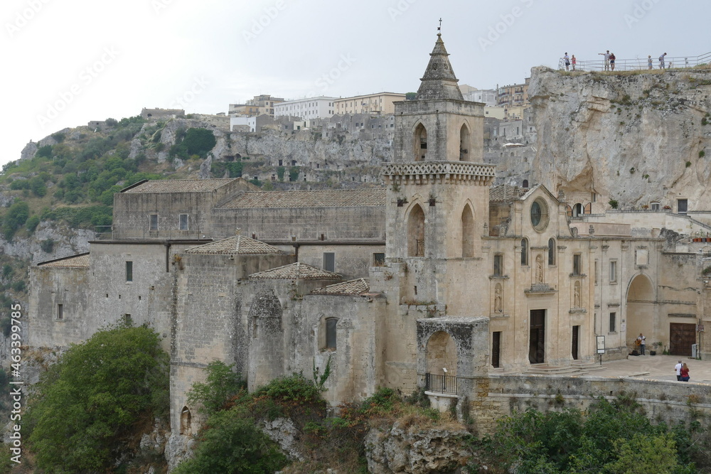 San Pietro Caveoso church in Matera placed on the precipice of the canyon carved by the Gravina River and on its right the arch that introduces in Sasso Caveoso
