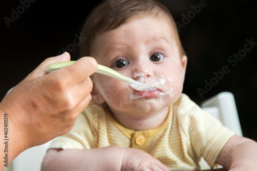 Happy baby with his mother during breakfast