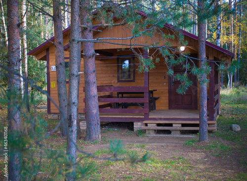 An old house on the edge of the forest. Cottage in the woods.