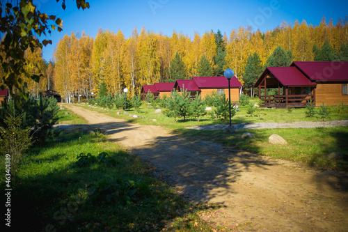 Urban-type cottage settlement. Autumn road. Small wooden houses.