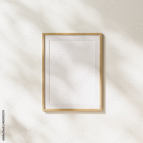 empty  light wood vertical poster frame with mat mock up with leaves shadows and sunlight on white wall background, 3d rendering