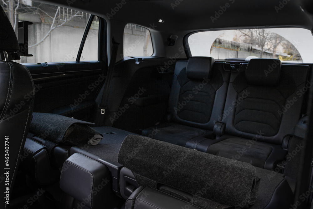 Folding seats and a cargo space inside suv car. Modern car interior. Huge, clean and empty car trunk.