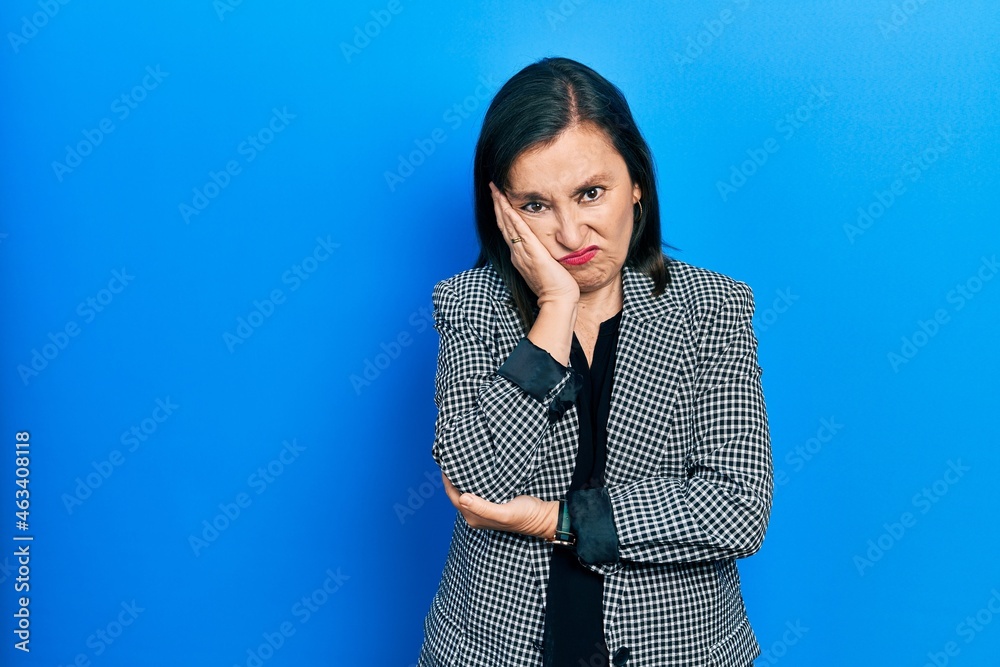 Middle age hispanic woman wearing business clothes thinking looking tired and bored with depression problems with crossed arms. Middle age hispanic woman wearing business clothes thinking looking tired and bored with depression problems with crossed arms.