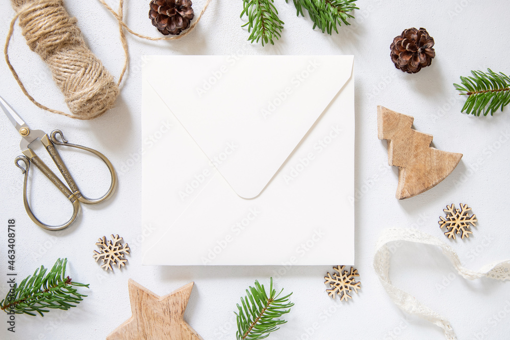 Obraz premium Christmas Composition with a card over sealed envelope flat lay