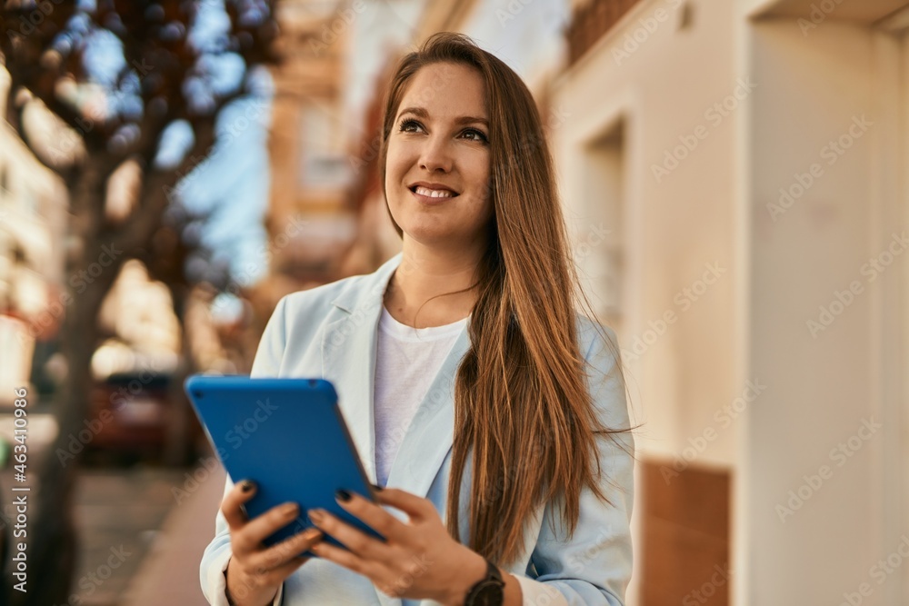 Young blonde businesswoman working using touchpad at the city. Young blonde businesswoman working using touchpad at the city.